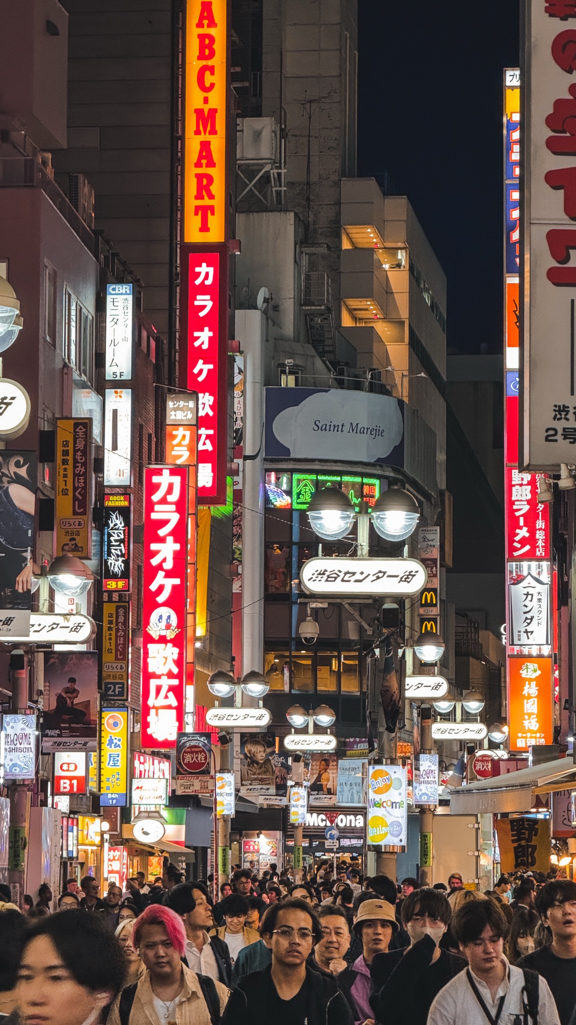 Tokyo street activity with pedestrians and urban scene, evening lighting