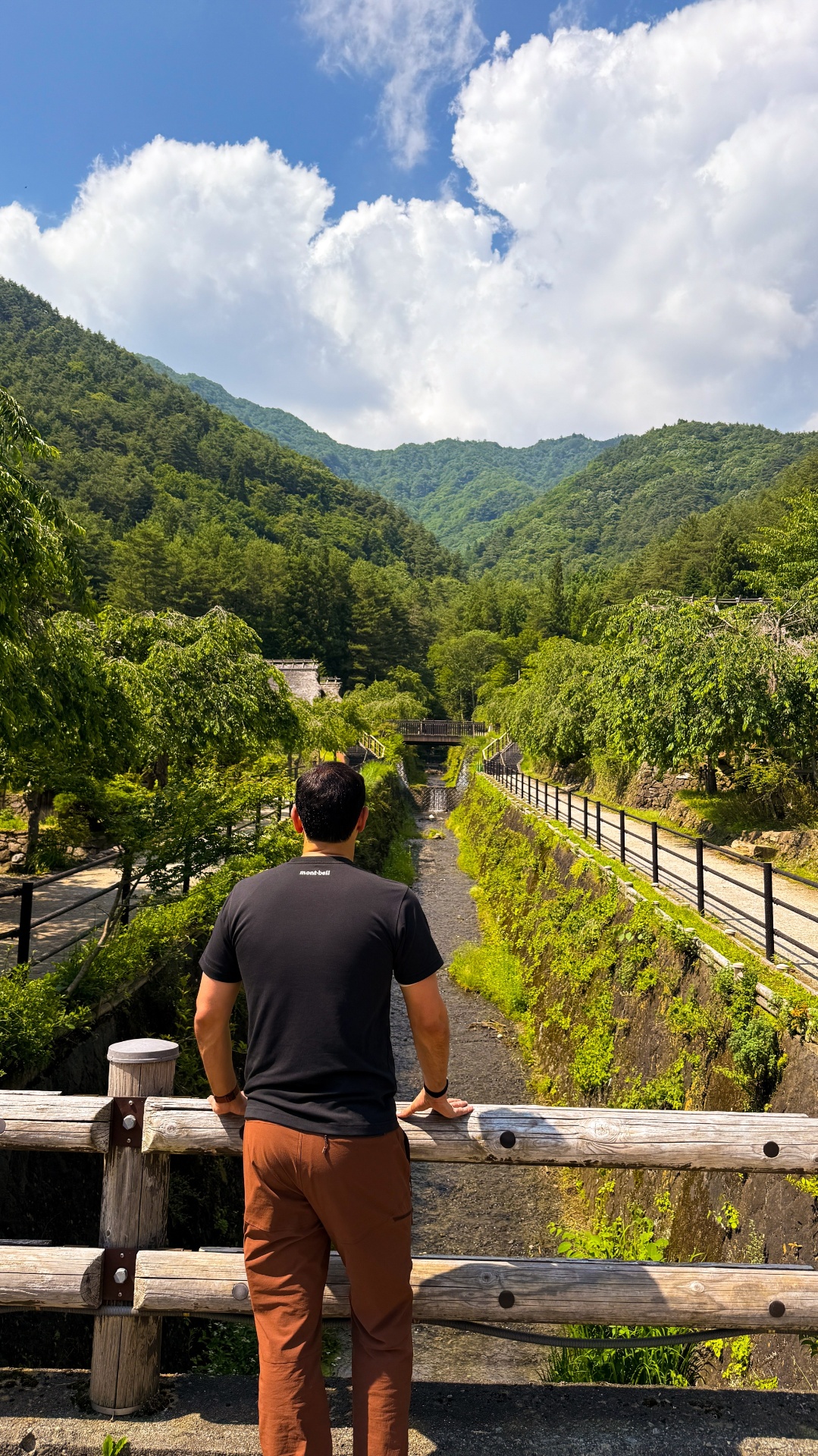 Mountain stream and forested valley behind Saiko Iyashi no Sato