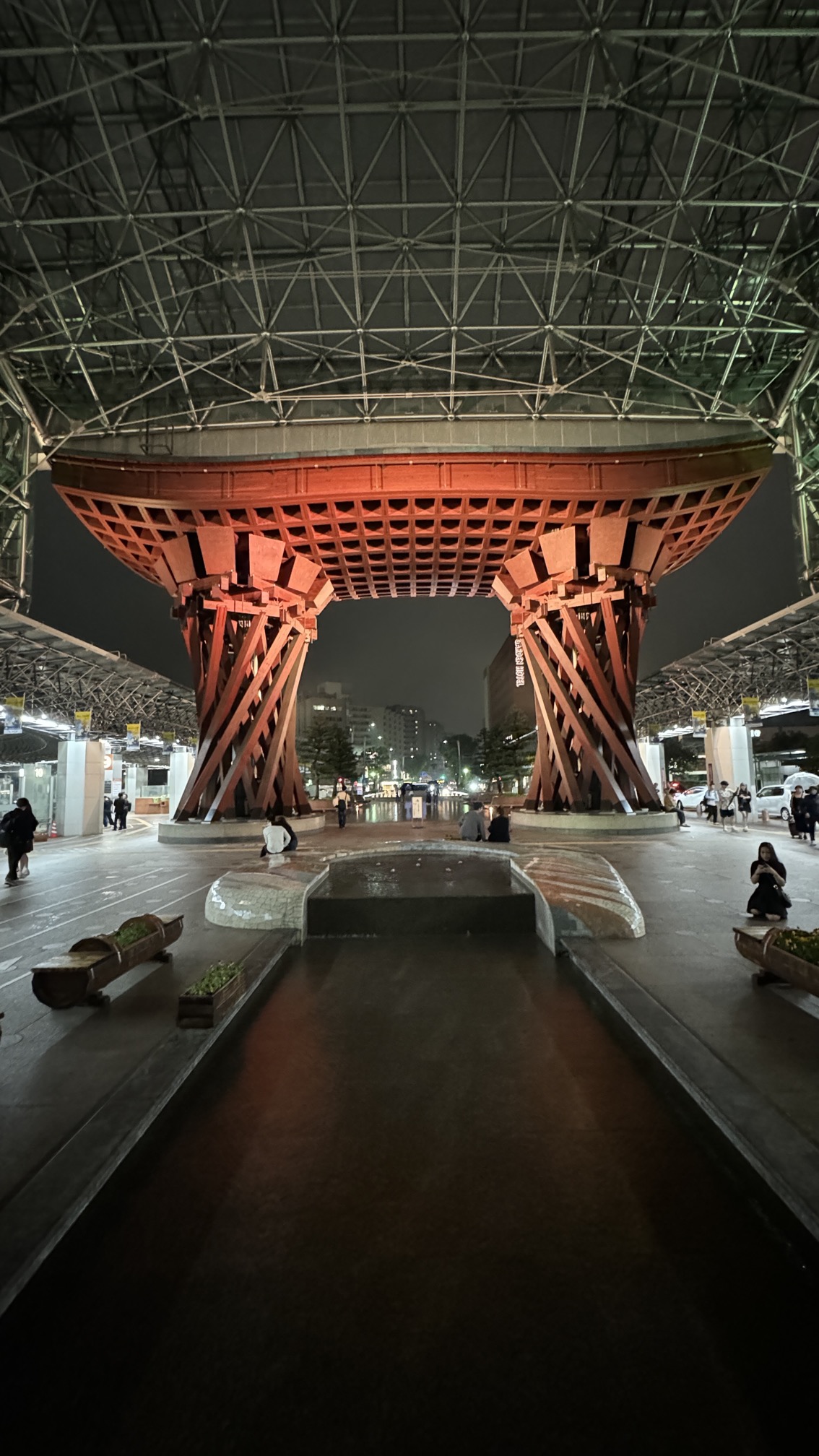 Red-painted traditional gatehouse at Kanazawa Station in evening light