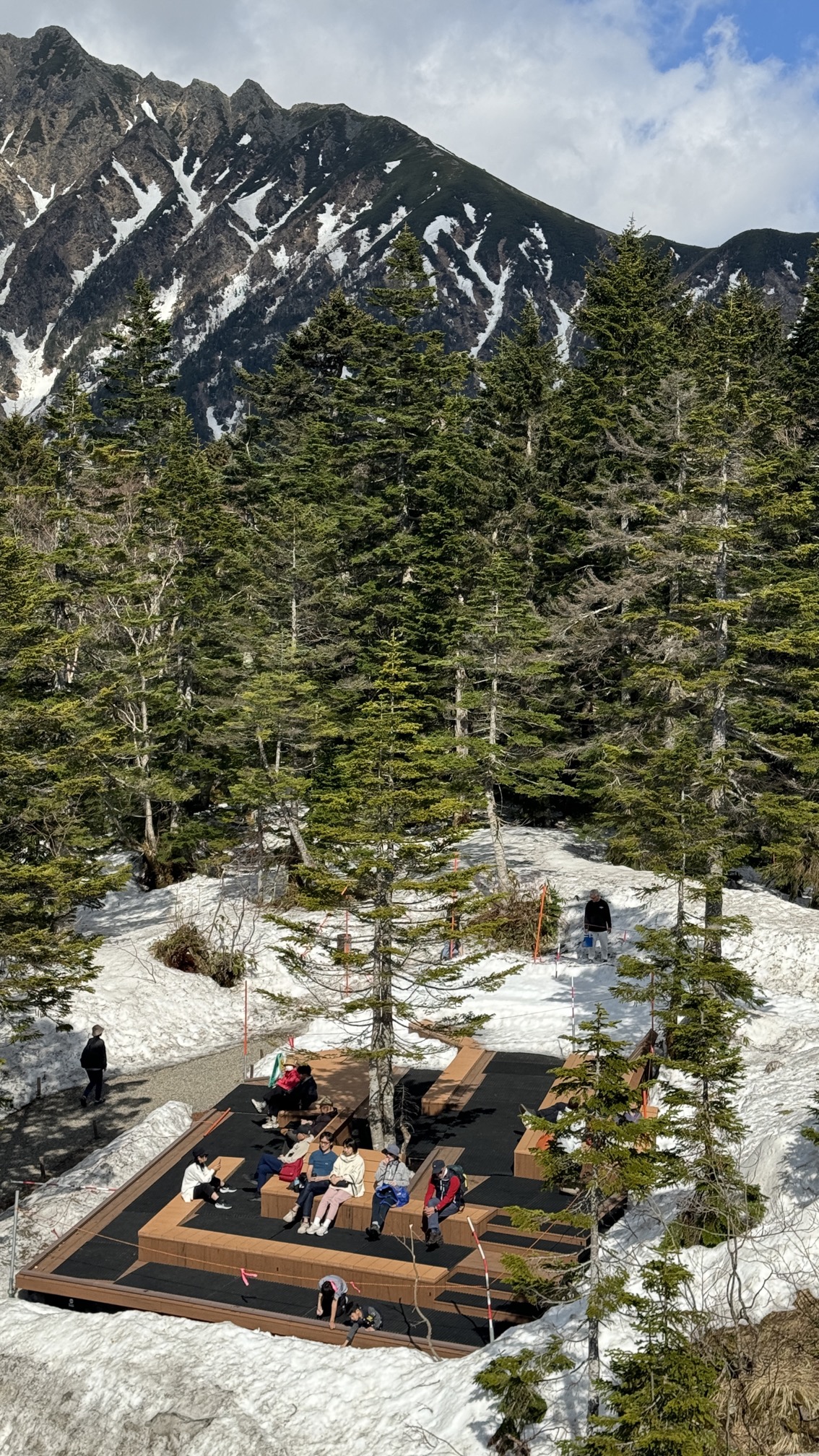 Mountain hiking post marker (2156m) with snowy alpine peaks in background