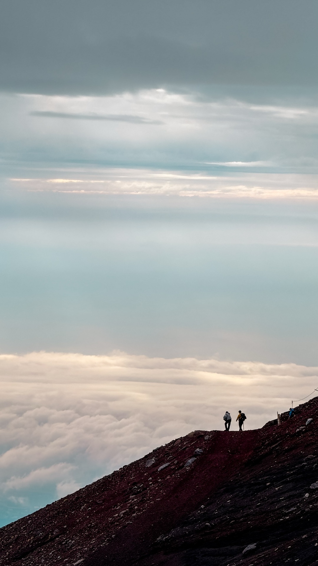Hikers above the clouds at the summit