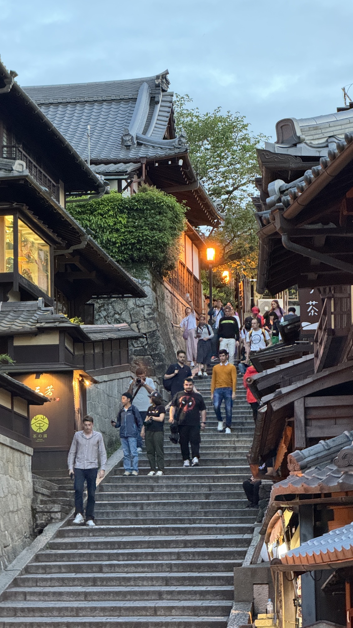 Gion geisha district street with traditional wooden machiya houses and warm evening lighting