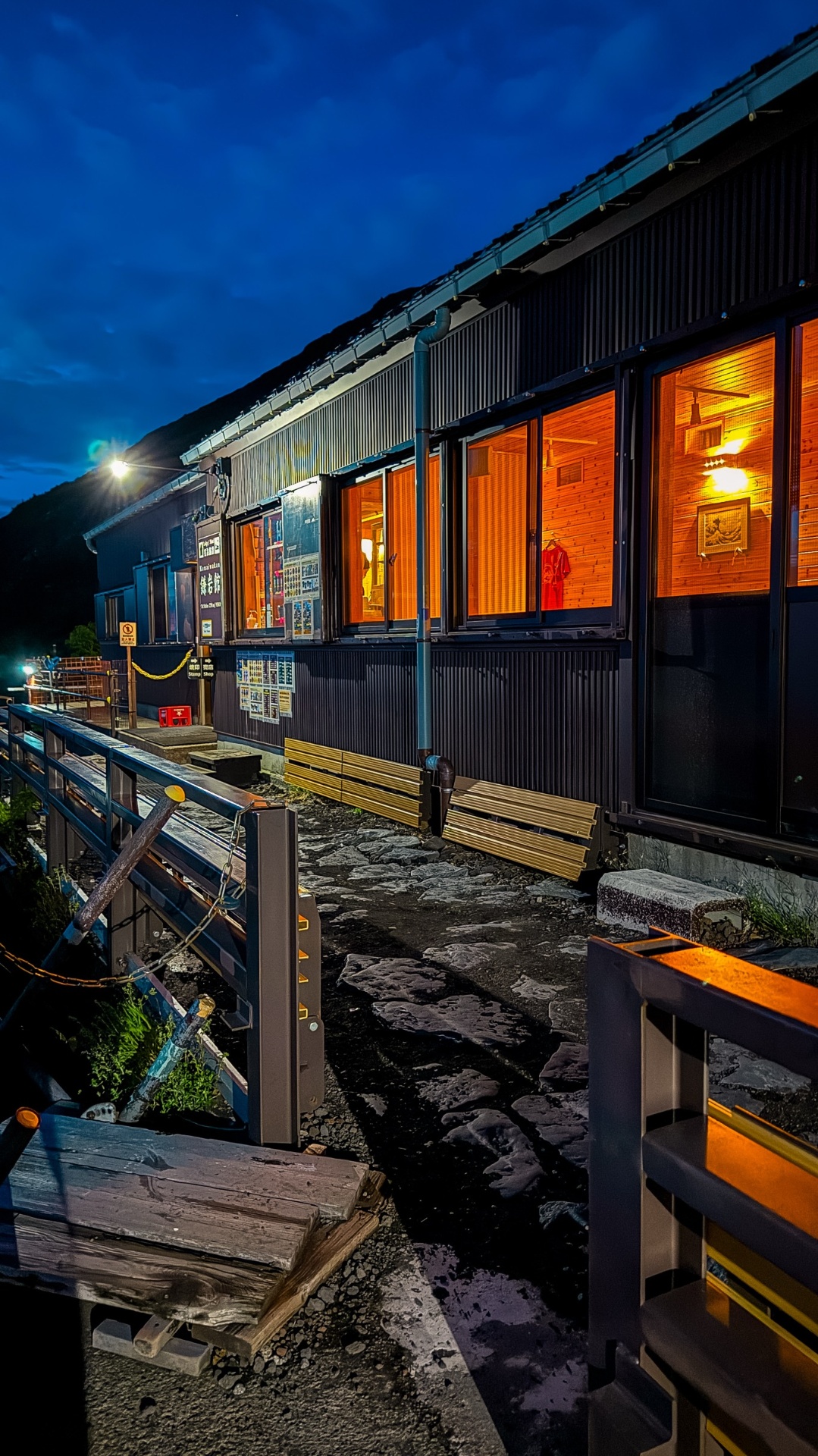 Mountain hut lit up in the blue hour on Mount Fuji