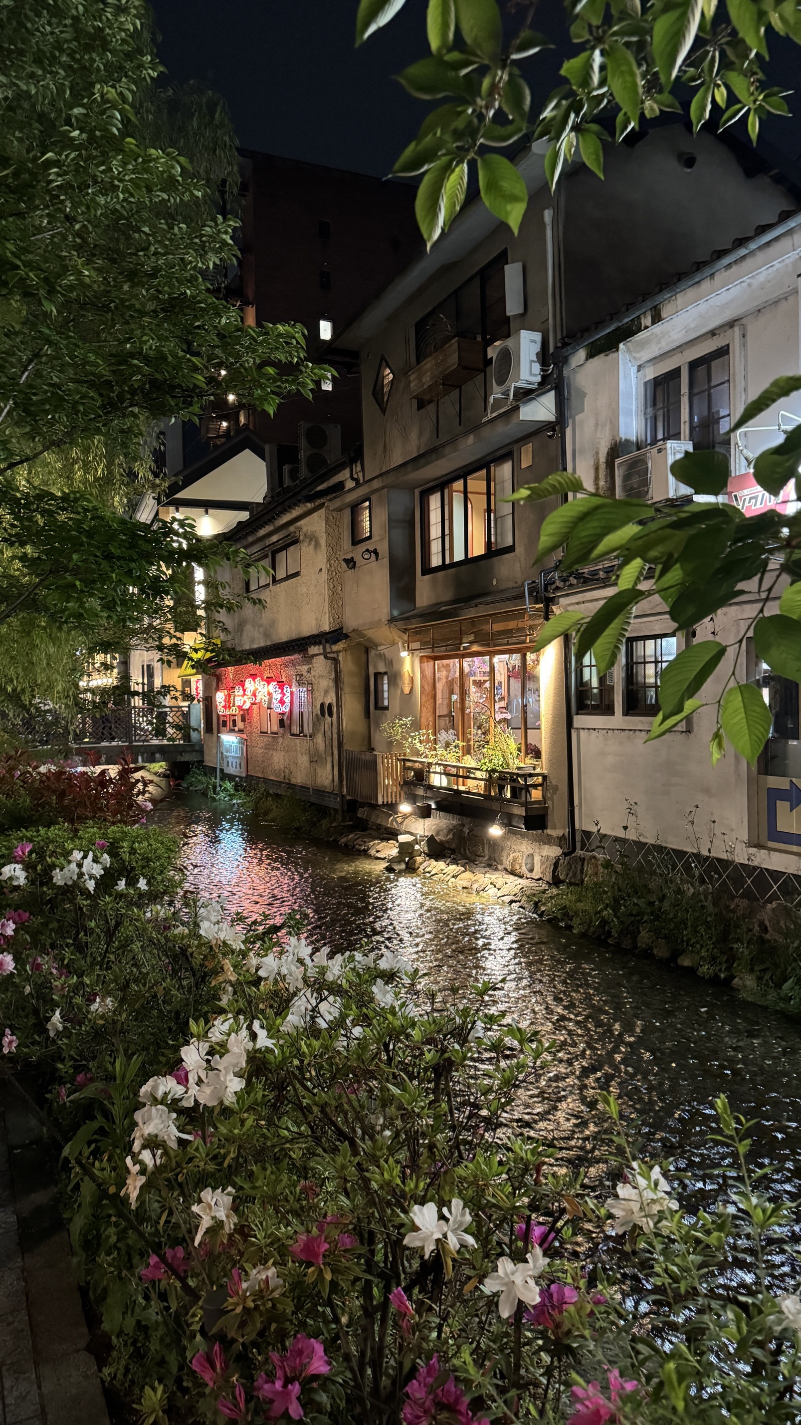 Kyoto street scene with traditional merchant district buildings and lanterns
