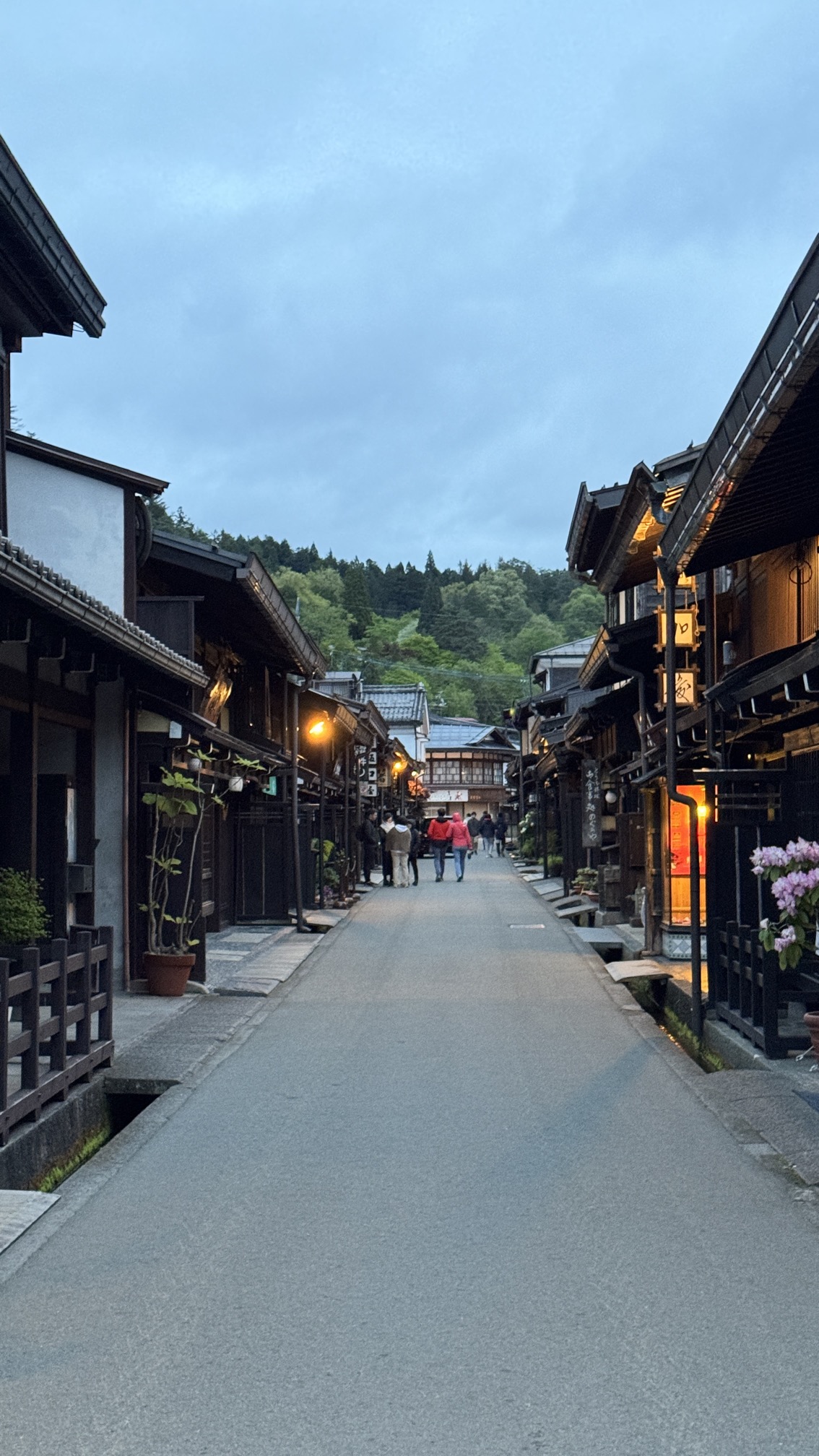 Historic Takayama old town street with wooden merchant buildings and evening lights