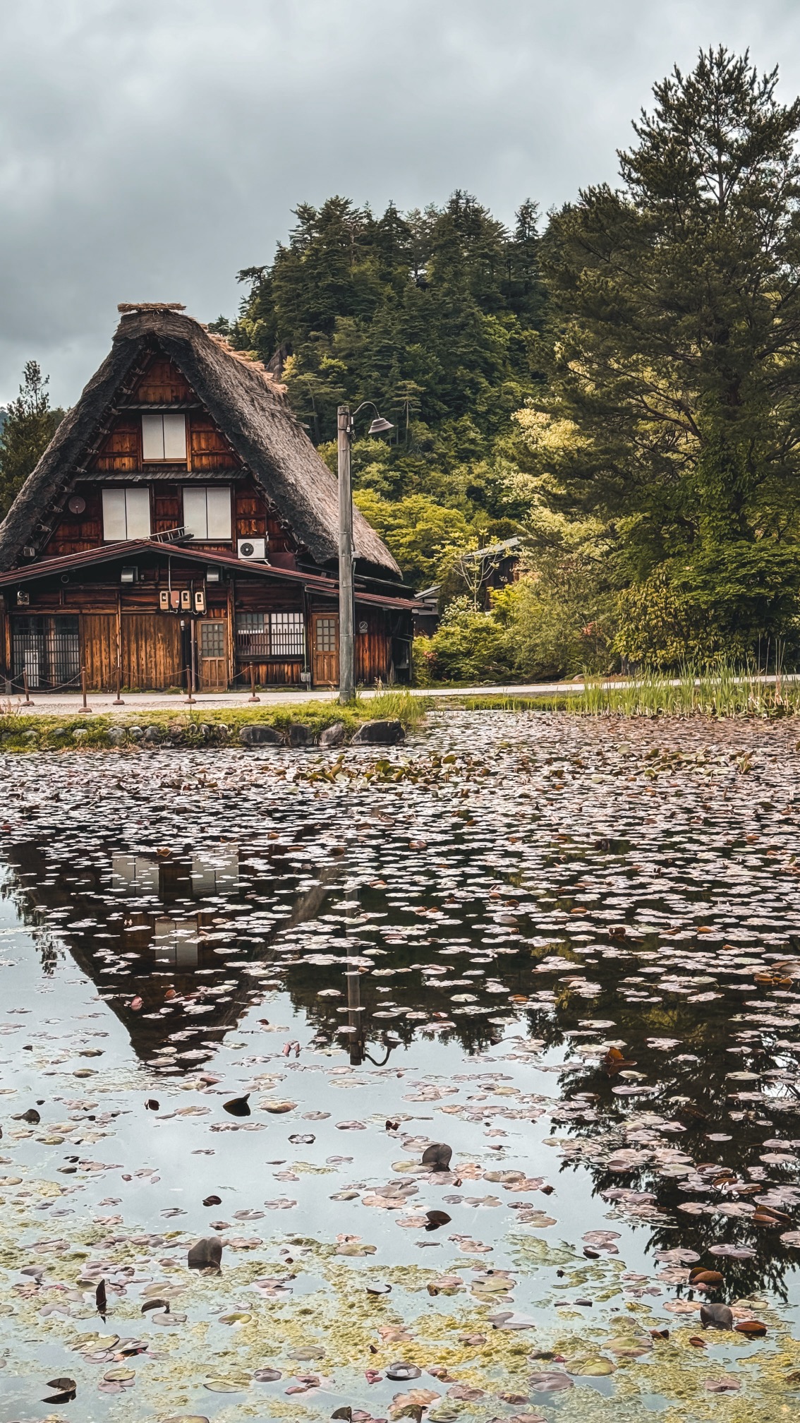 Traditional farmhouse entrance with wooden beams and stepping stones, UNESCO village