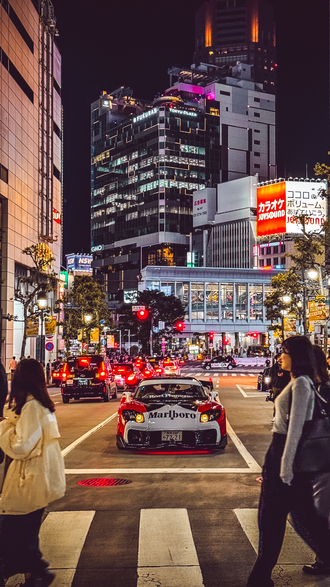 Iconic Shibuya Crossing with thousands of people crossing intersection, Tokyo