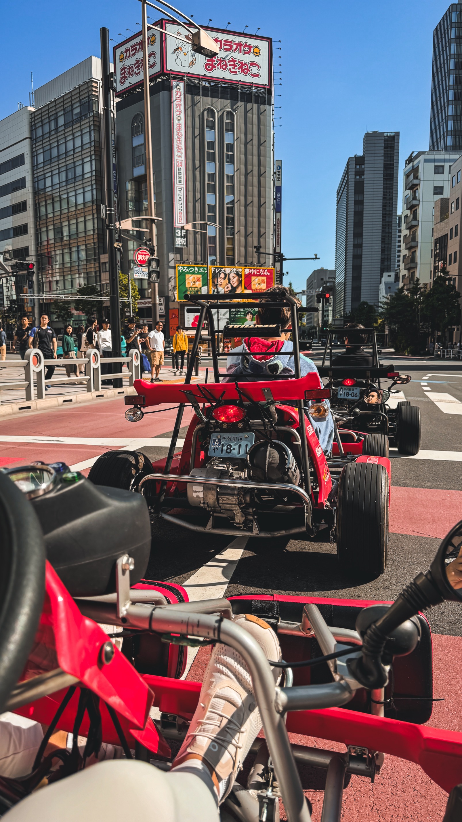 Mario Kart go-kart tour vehicle on Tokyo street with character costumes