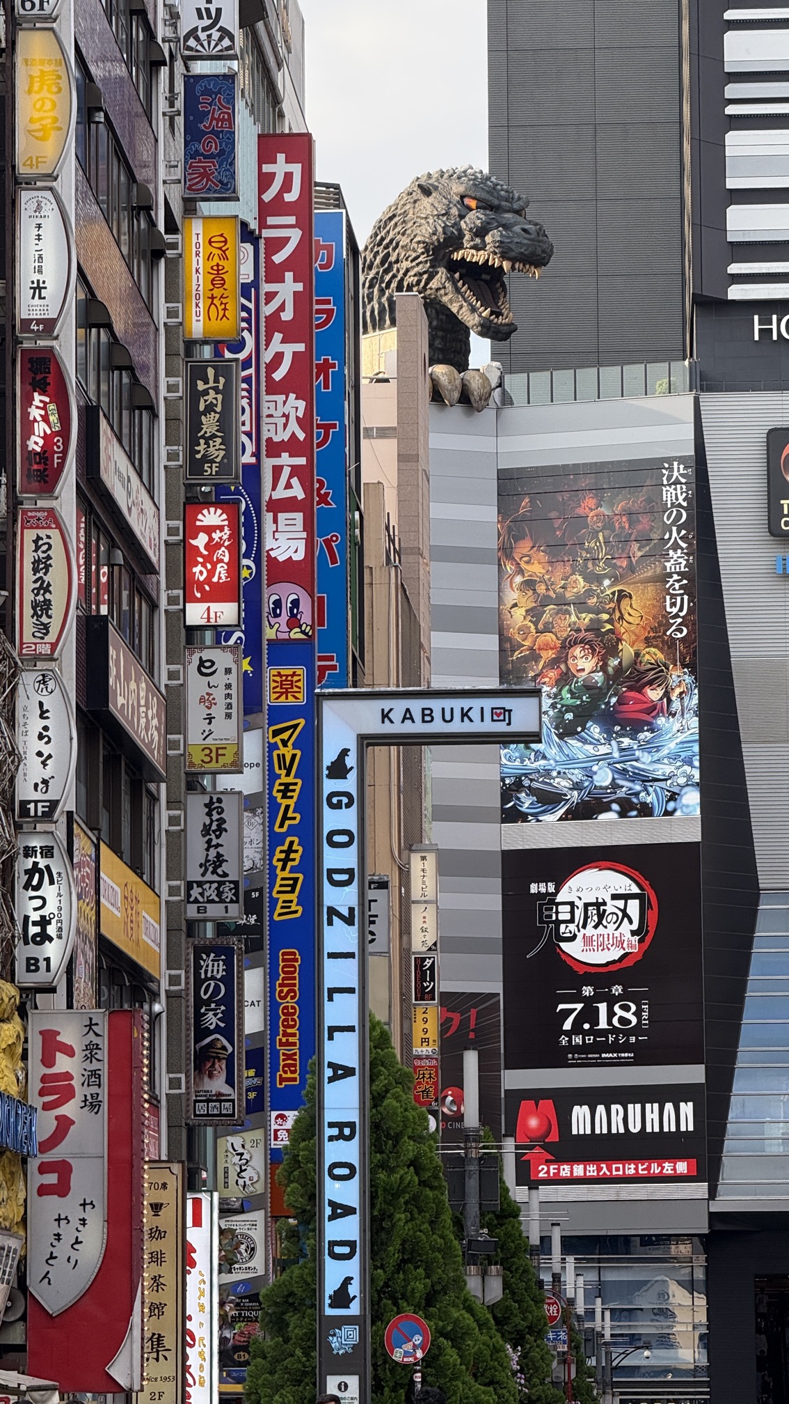 Shinjuku neon sign district at dusk with bright advertising billboards, Tokyo